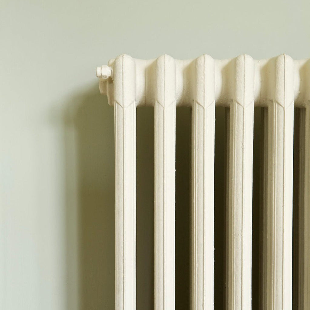 Wall painted in Farrow & Ball Blue Gray No.91 with white cast iron radiator in front.
