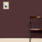Wall painted Farrow & Ball Brinjal No.222 with a wooden chair in front and a small painting on the wall.
